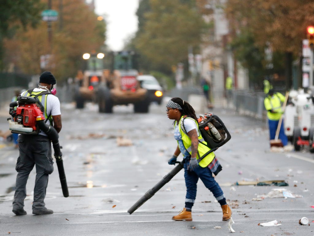 Workers use blowers during the cleanup process along Benjamin Franklin Parkway   in Philadelphia a day after Pope Francis concluded his 10-day trip to Cuba and the United States.