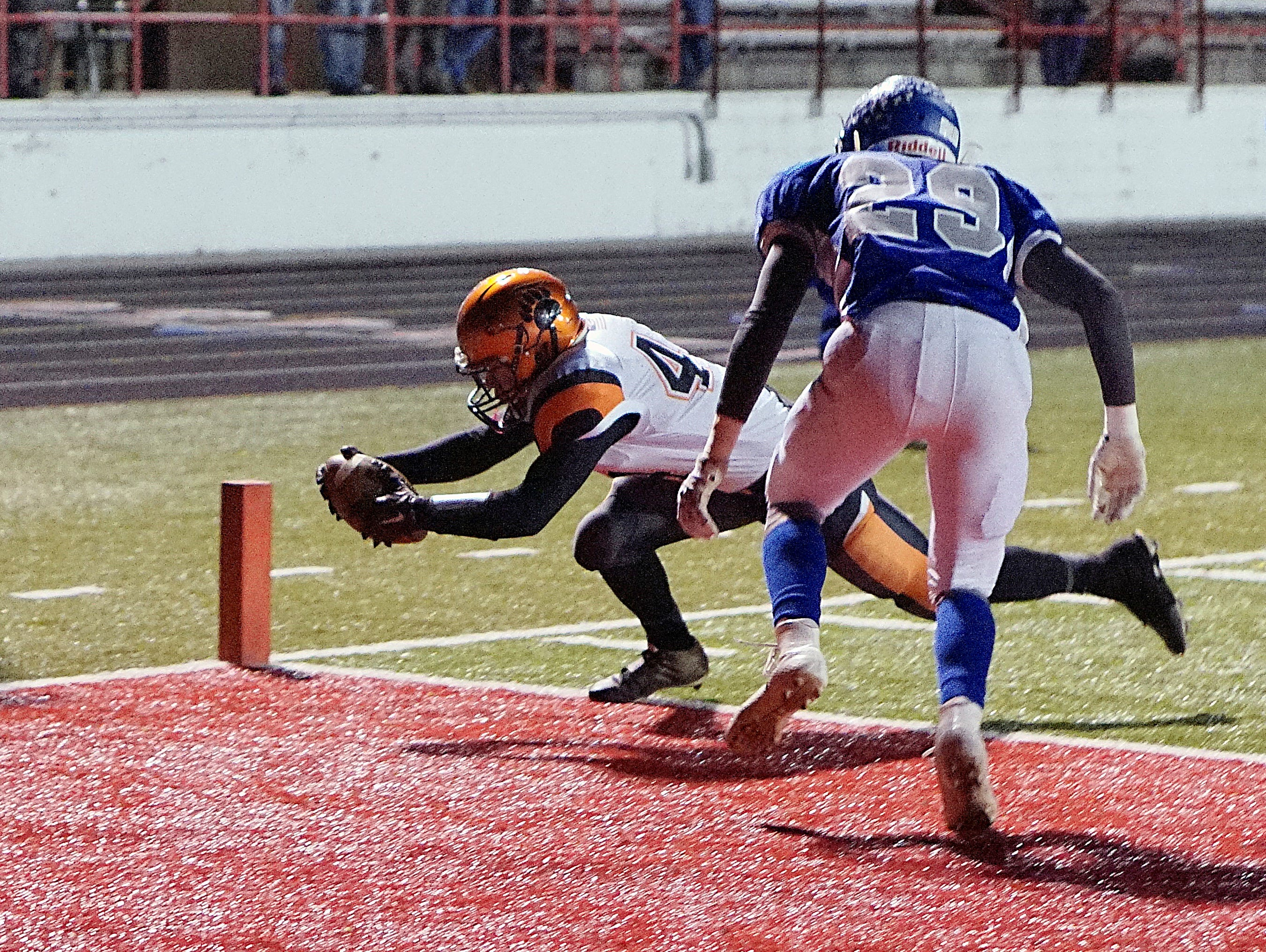 Lucas' Jeb Grover dives for a touchdown against Calvert Friday night at Bellevue High School.