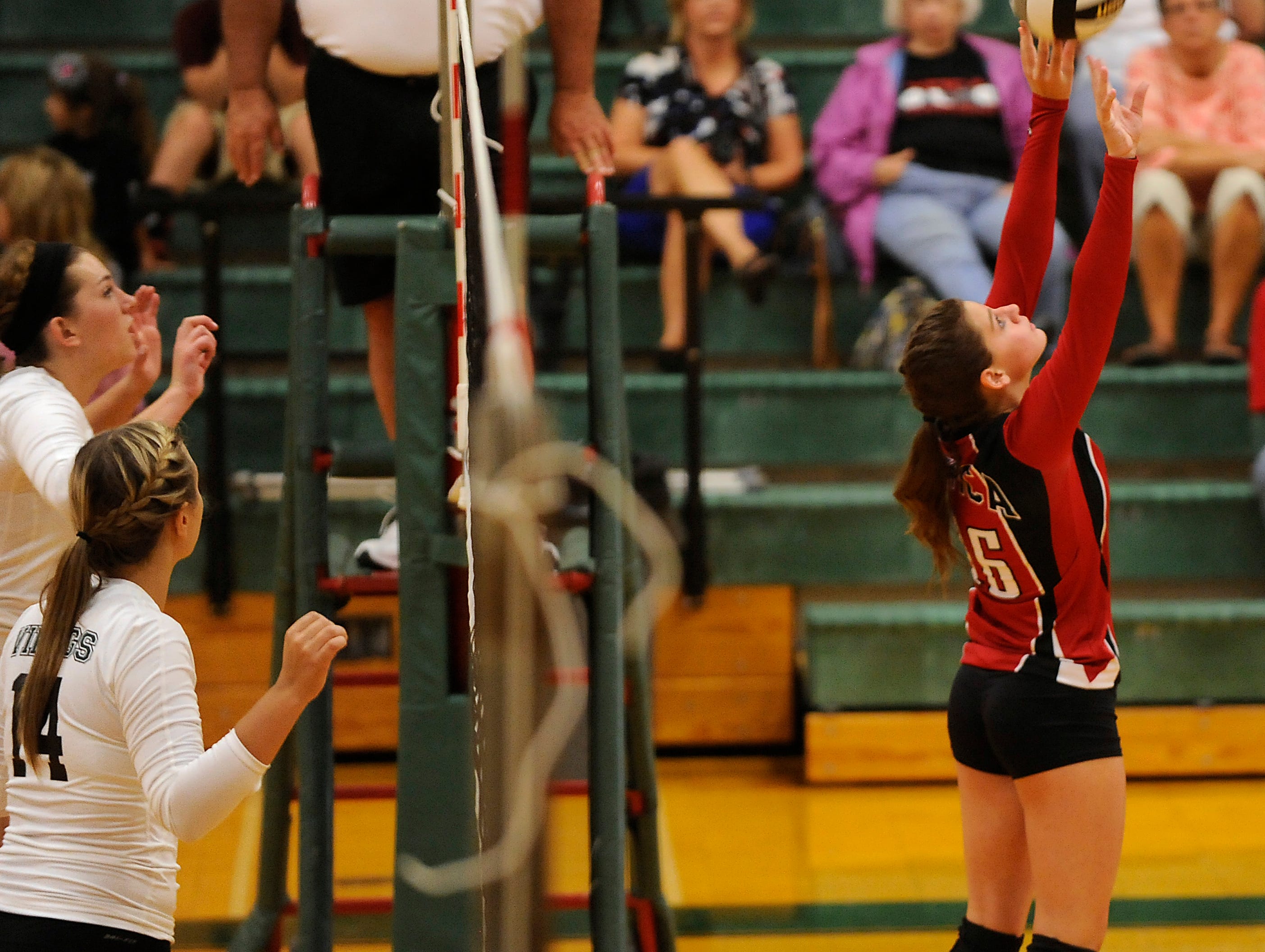 Northridge’s Savannah Legg and Jamie Swickard prepare to block as Utica’s Brooke Maxwell sets up a teammate for a hit during Thursday’s Licking County League match.