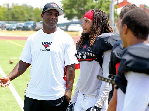 University of the Incarnate Word new assistant football coach Ricky Williams, left, talks with players during an NCAA college football practice on Aug. 15.