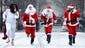 People dressed as Santa Claus run at Tompkins Square Park during the annual SantaCon bar crawl Dec. 14 in New York City.