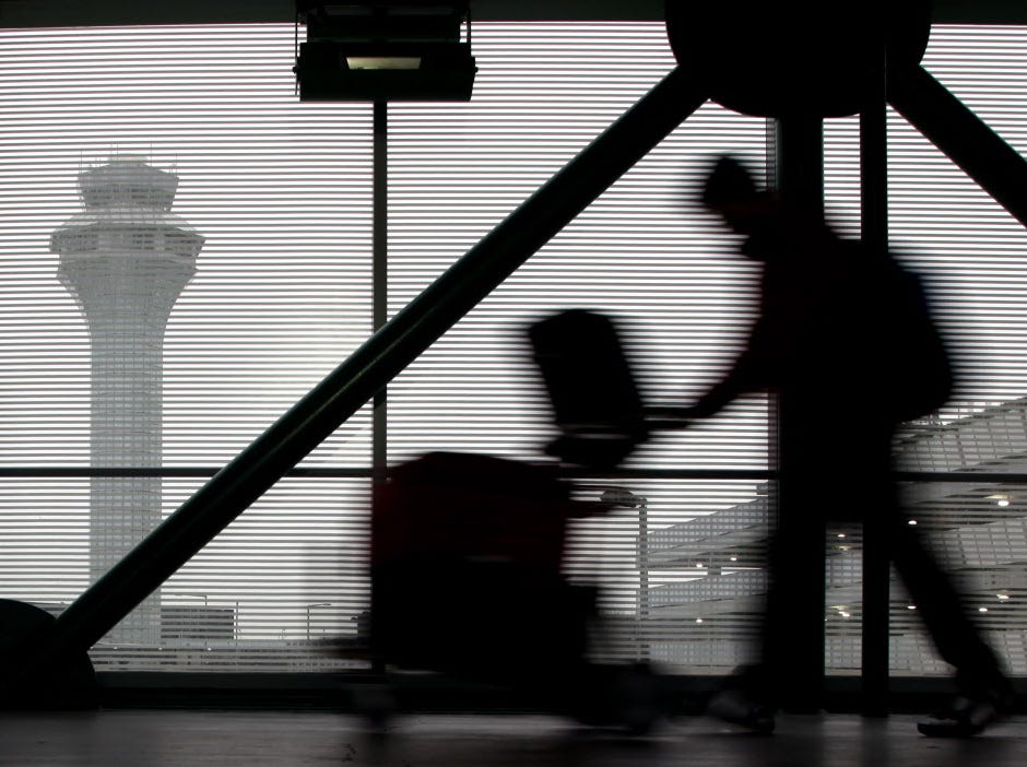 A traveler walks through O'Hare International Airport in Chicago on Dec. 21, 2013. A new consumer group called Travelers' Voice announced it would advocate for safe, competitive airline travel.