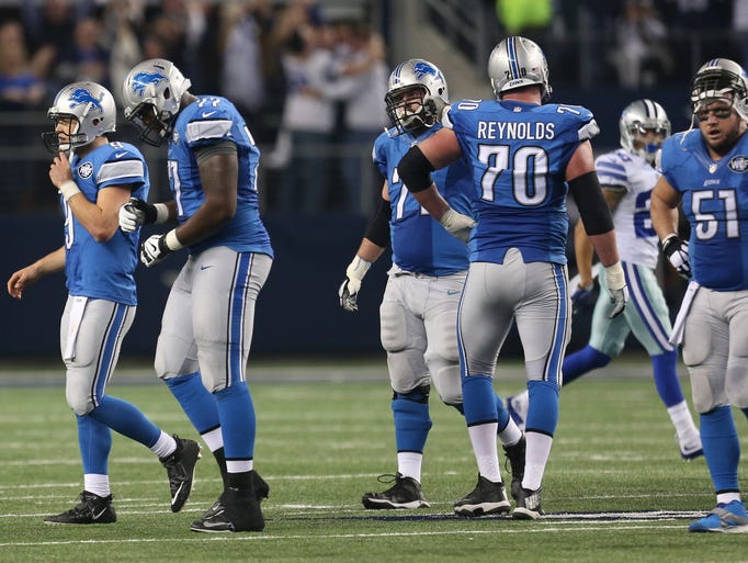 The Detroit Lions leave the field after a Matthew Stafford