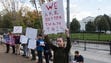Protestors hold signs against President-elect Donald