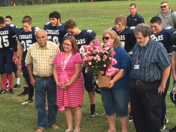 MIC football presented flowers to (left to right) Dennis Brogdon, Paula Brogdon, Sue Cottrell and Tim Cottrell in recognition of Breast Cancer Awareness.
