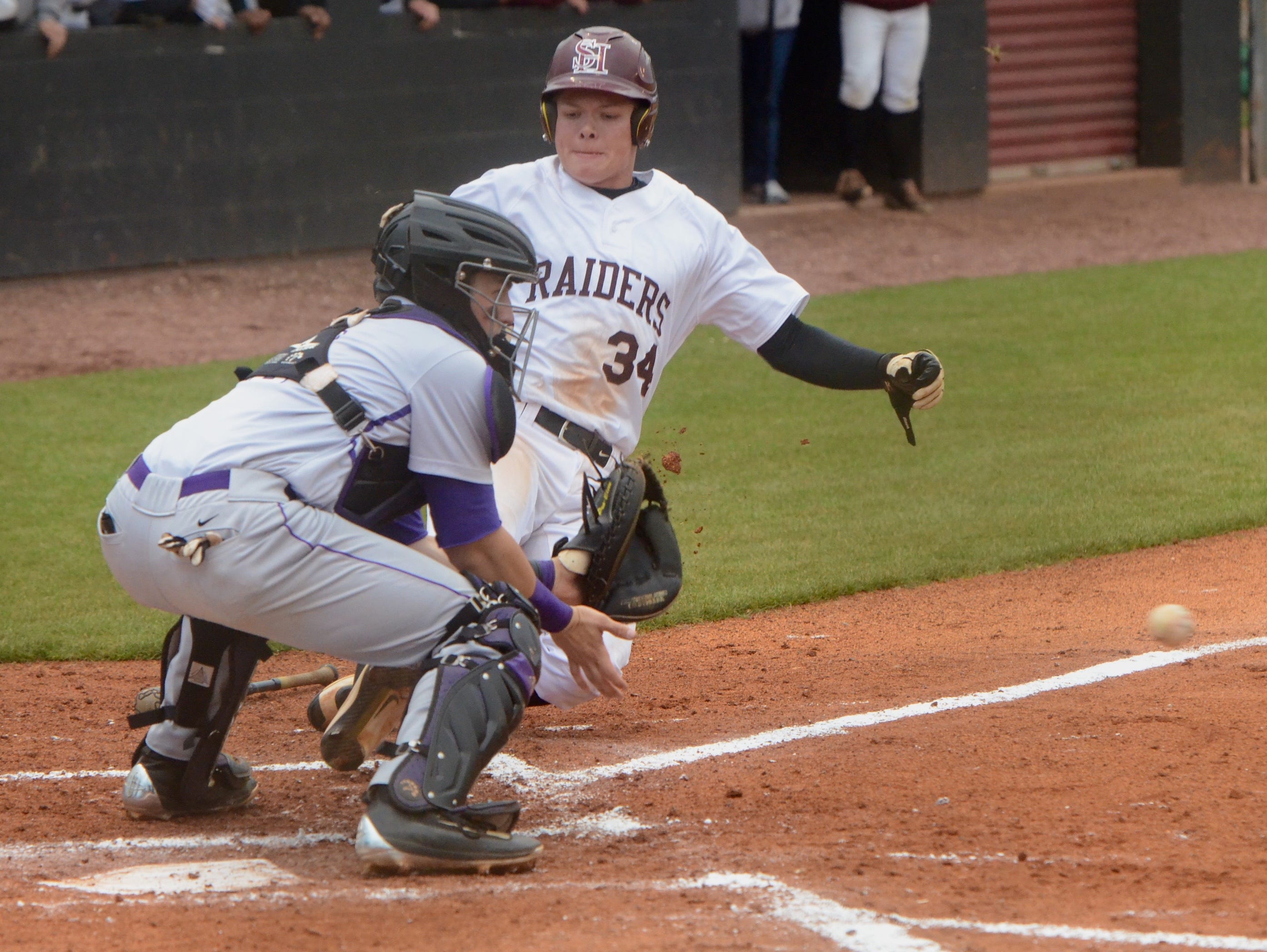 Spring Hill’s Hunter Whitwell slides into home plate ahead of the throw to CPA catcher Philip Clarke during the second inning of Wednesday’s Region 6-AA championship at Spring Hill High School.