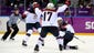 USA forward Meghan Duggan (10) celebrates with forward Jocelyne Lamoureux (17) and defenseman Kacey Bellamy (22) after scoring a goal against Canada.