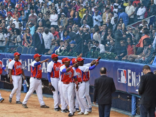 Members of the Cuban national team wave to Cuban President