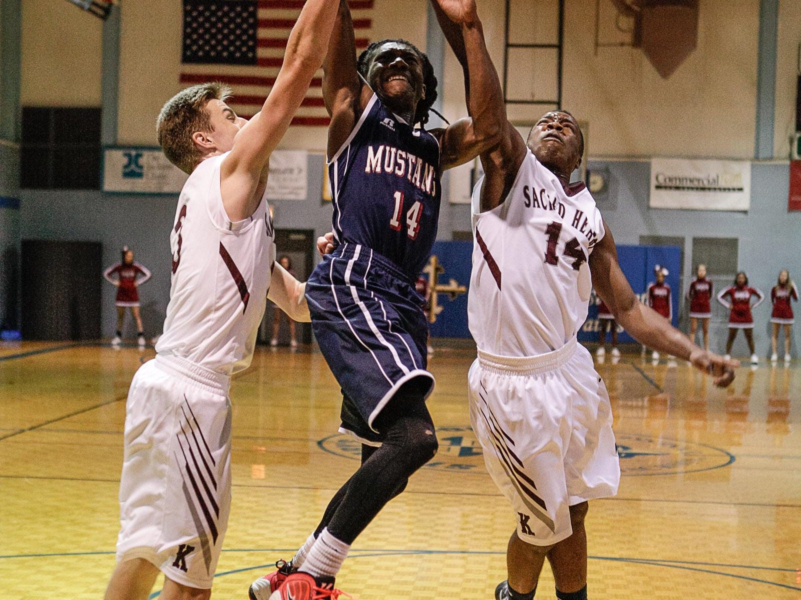 Madison’s Marquese Parram goes up for a shot Friday against Sacred Heart.