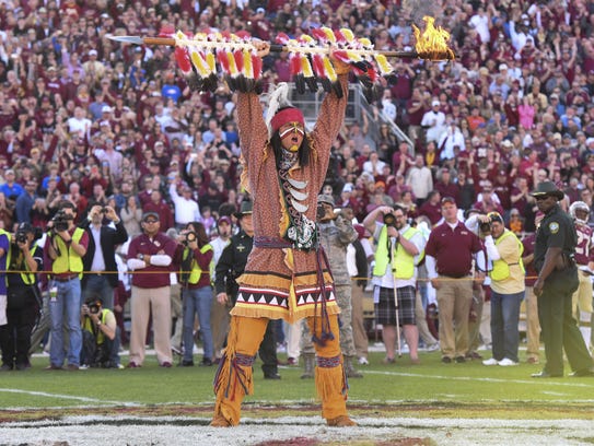 Chief Osceola prepares to plant his spear at midfield