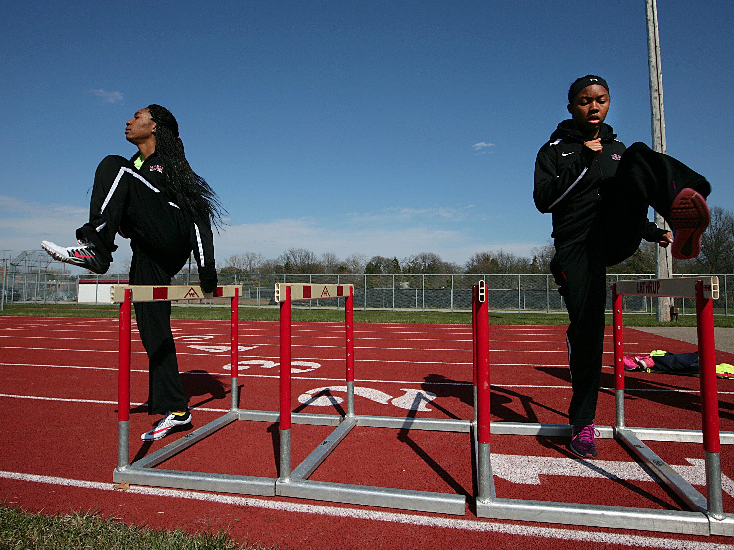 Oak Park’s Brianna Holloway, left, and Anna Jefferson warm up before a meet Wednesday. “When we say we’re from Oak Park, teams in the state don’t like us,” said Jefferson.