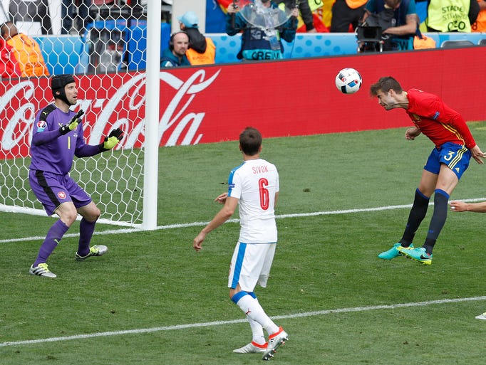 Spain's Gerard Pique, second right, scores the opening