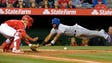 April 9: Rangers' Elvis Andrus dives to the plate but