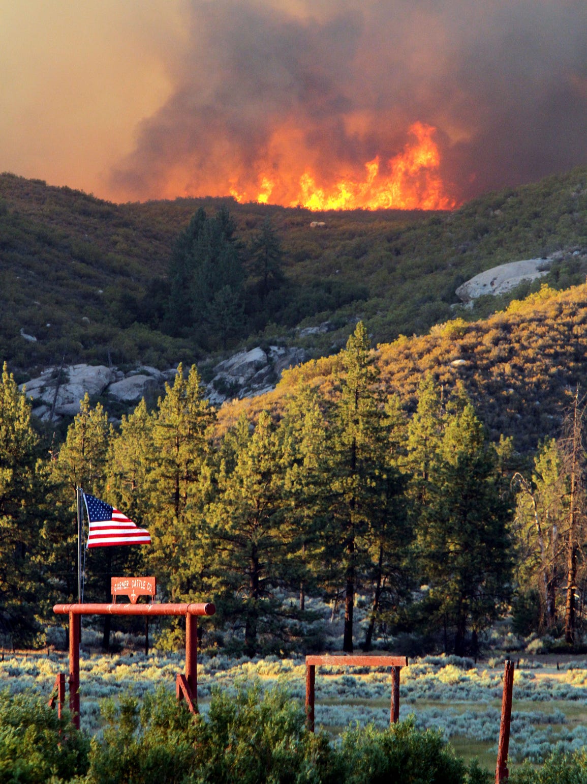 The Mountain Fire burns over a ridgeline behind the