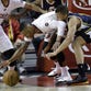 Utah Jazz guard Dante Exum, right, is hit in the face by Portland Trail Blazers guard Damian Lillard's elbow as they chase down a loose ball during the first half of an NBA basketball game  in Portland, Ore., Saturday, April 11, 2015. Lillard was called for a foul on the play.