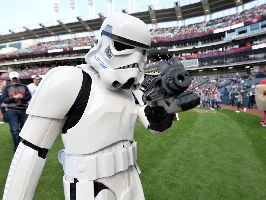 A Star Wars stormtrooper takes aim as he walks off the field before the game between the Cleveland Indians and the Kansas City Royals at Progressive Field. The Stormtroopers were in attendance for Star Wars fireworks night.