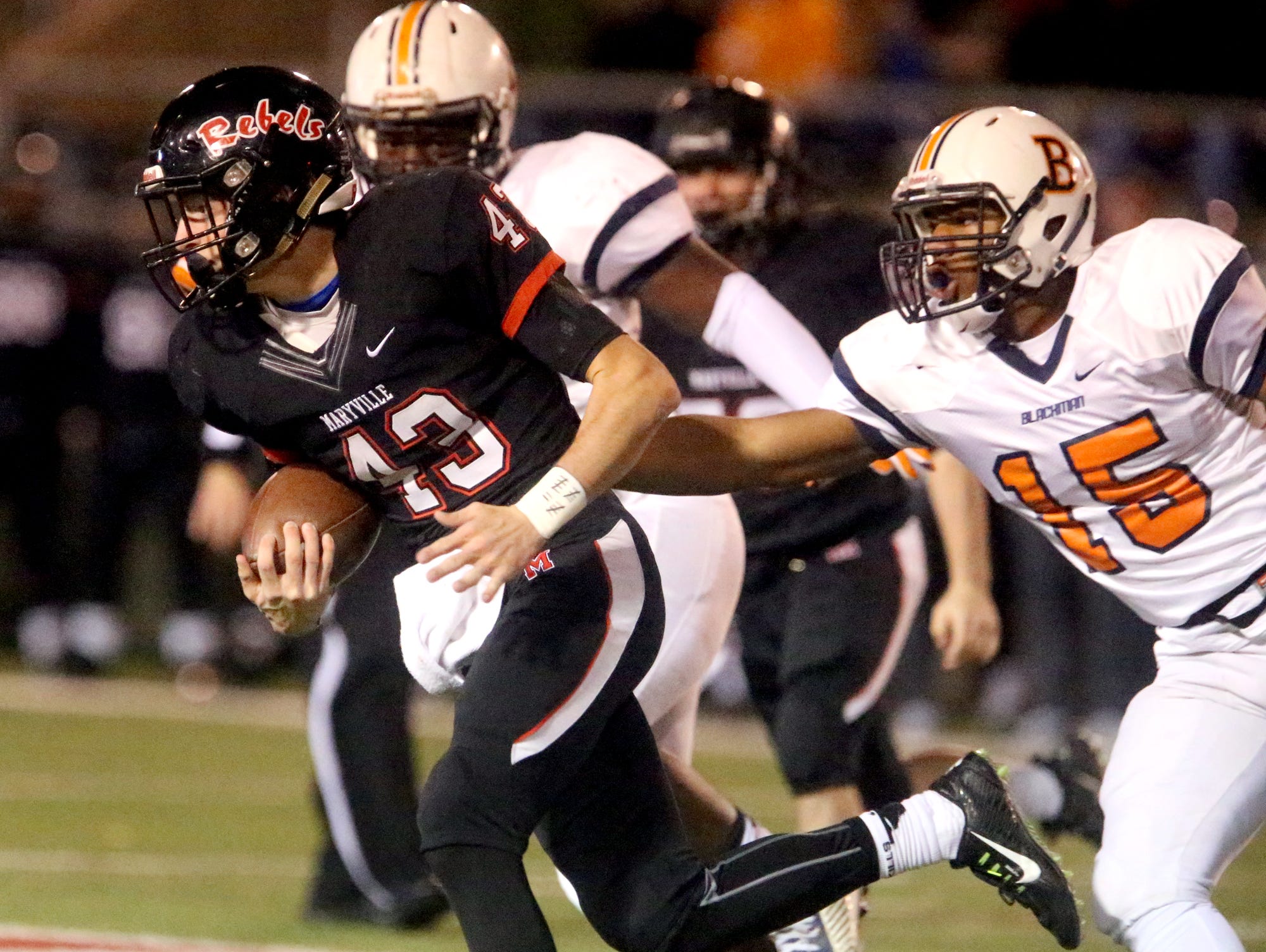 Maryville's Joel Hopkins (43) runs the ball as Blackman's Donnel Bailey (15) tries to stop Hopkins during the quarterfinal game, at Maryville, on Friday, Nov. 20, 2015.