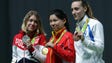 Mengxue Zhang of China, middle, holds her gold medal