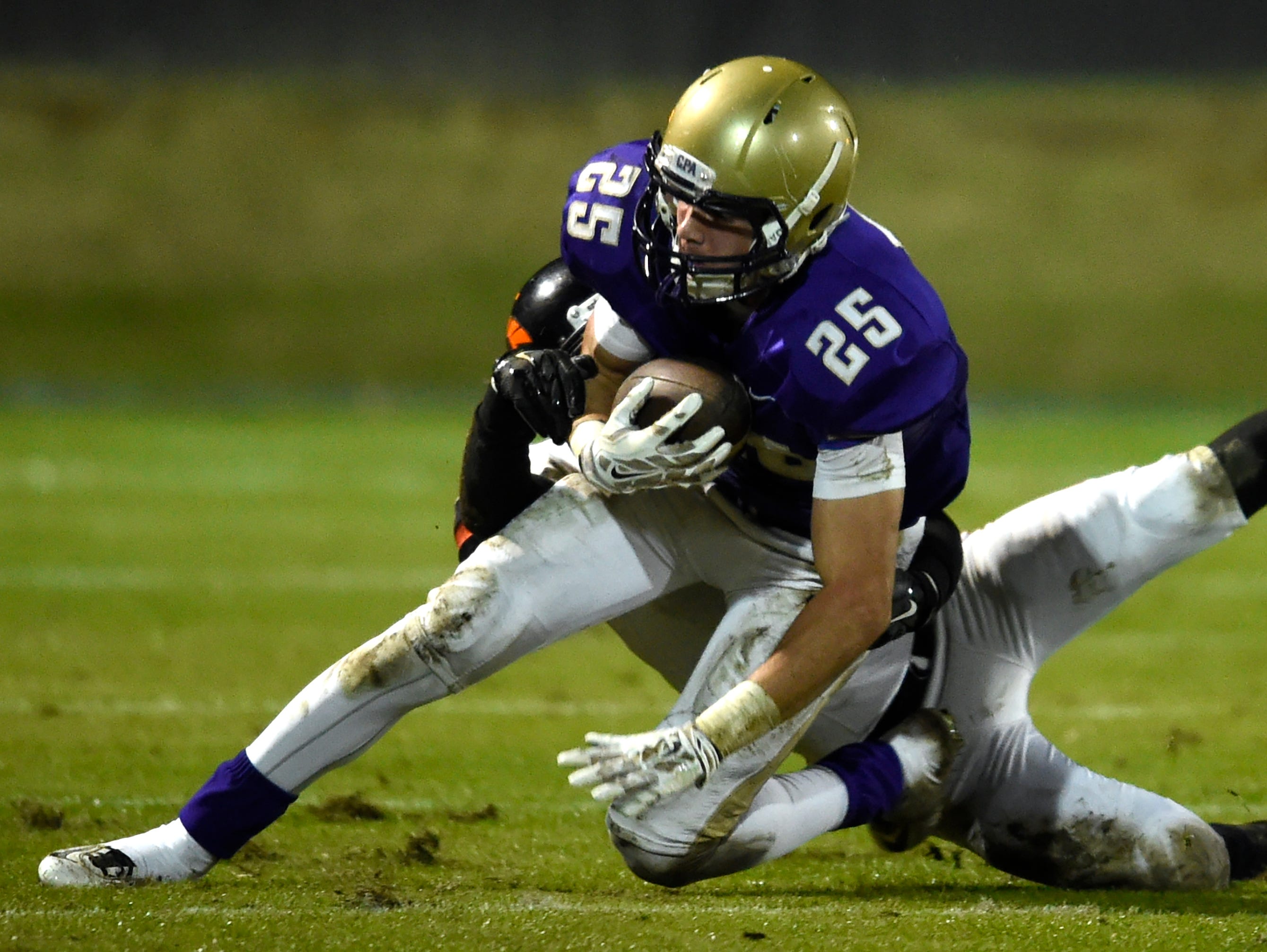 CPA running back Wallace Barrett (25) is pulled down by Startford's William Summers (5) as he runs the ball during their game Friday Nov. 13, 2015, in Nashville, Tenn.