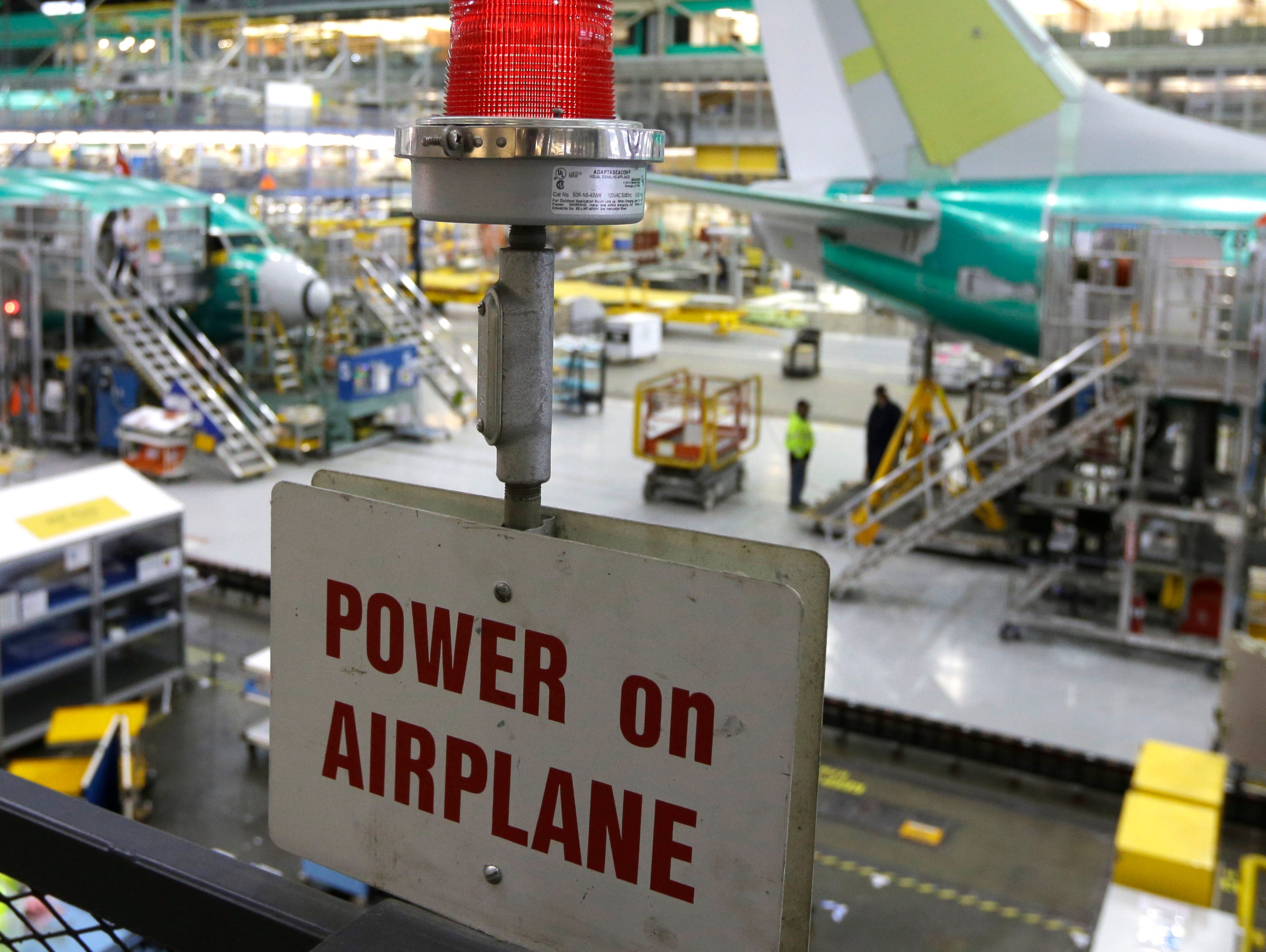 A sign indicates that power is turned on Tuesday, Dec. 16, 2014, at Boeing's 737 assembly facility in Renton, Wash.