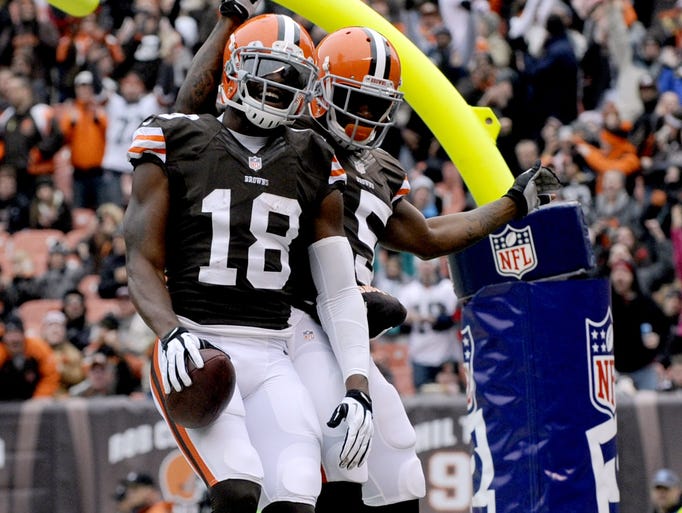 Dec 1, 2013; Cleveland, OH, USA; Cleveland Browns wide receiver Greg Little (18) and wide receiver Davone Bess (15) celebrate Little's third quarter touchdown against the Jacksonville Jaguars at FirstEnergy Stadium. The Jaguars beat the Browns 32-28. Mandatory Credit: Ken Blaze-USA TODAY Sports