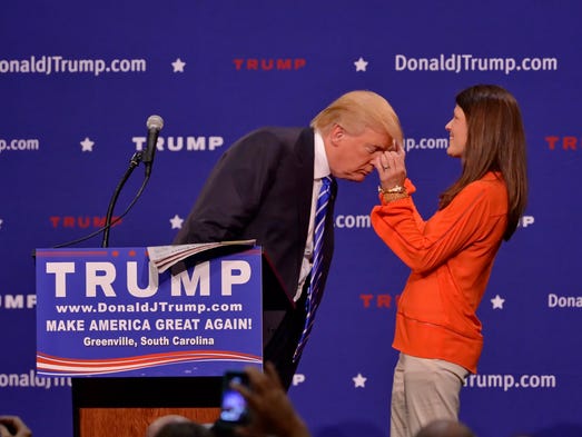 Trump asks a supporter, Mary Margaret Bannister, check