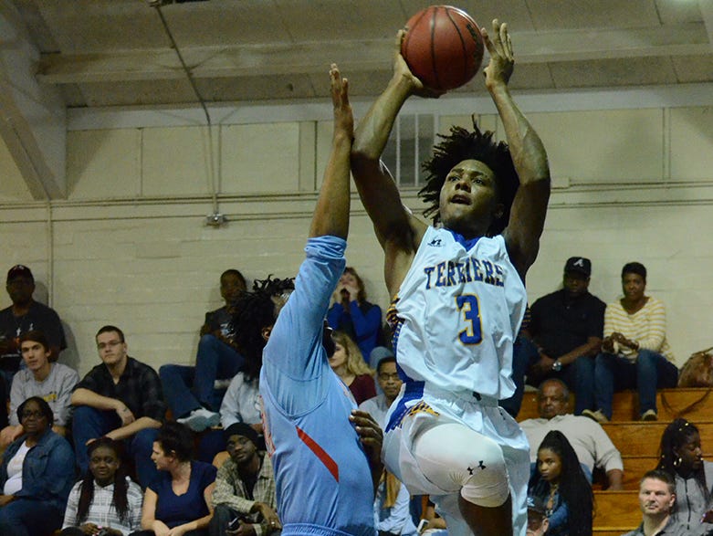 Dekario Qquendo (3) gets some air Friday night over Raider Dorien Josey. (photo by Tony Dees/for Florida Today)