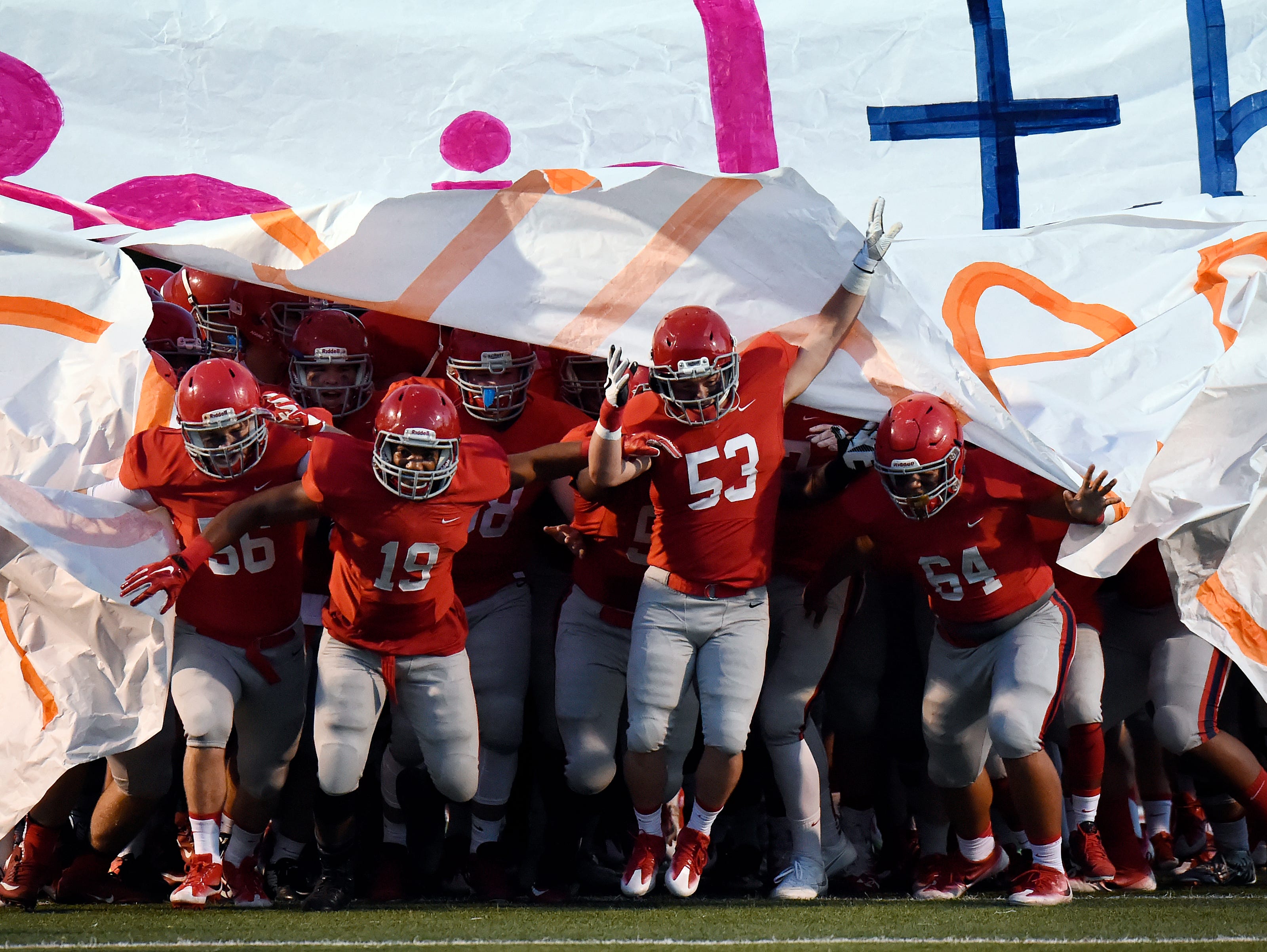Brentwood Academy football players run onto the field before an high school football game against Baylor on Friday, Sept. 16, 2016, in Brentwood, Tenn.