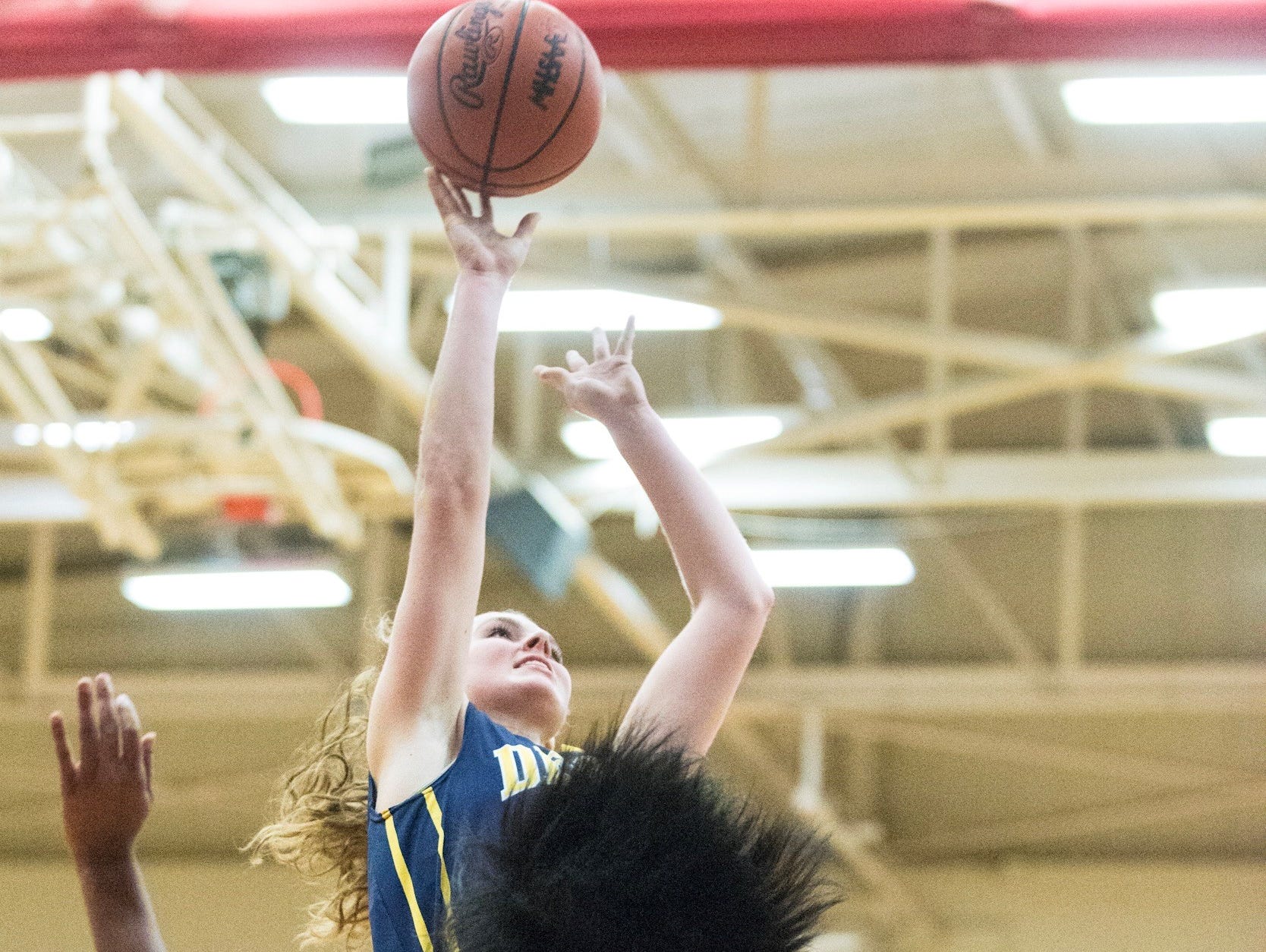 Grace George,top, of DeWitt knocks down a jump shot over Jalina Crawford ,20, of Everett during their season opening game Tuesday Lansing.