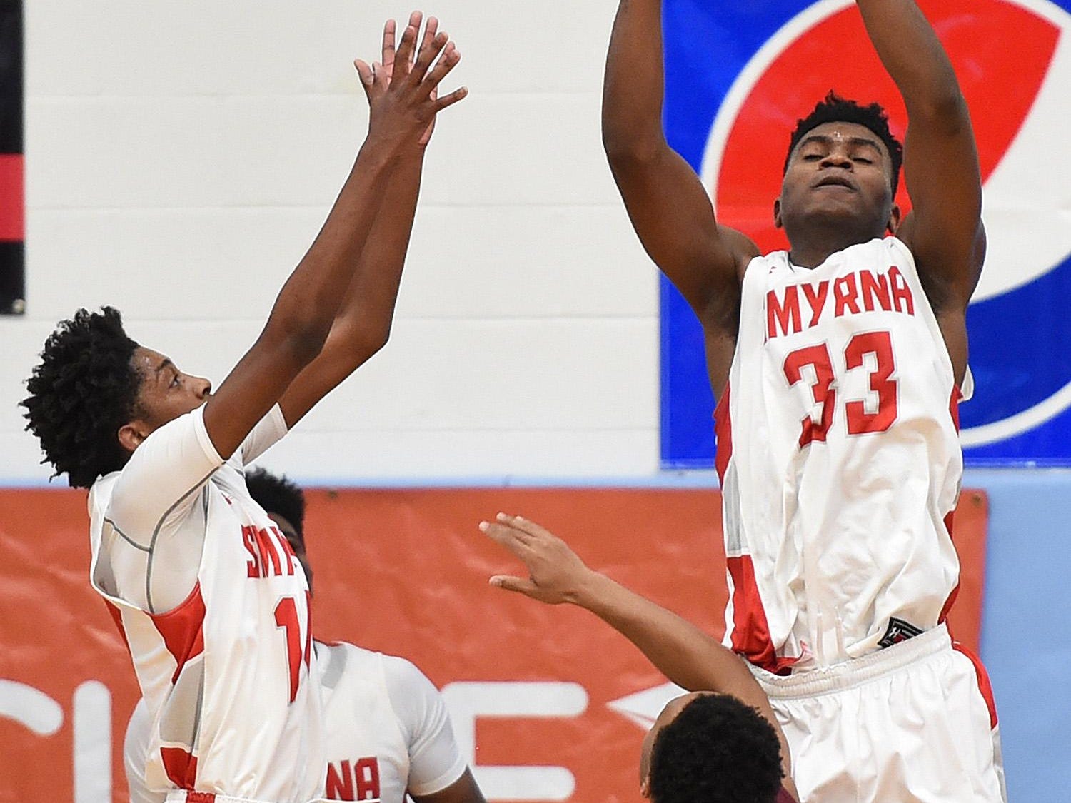 Smyrna's #33 Azubuike Nwankwo grabs a rebound as The Annual Slam Dunk to the Beach Basketball Tournament started at Cape Henlopen High School in Lewes on Tuesday December 27th with Smyrna HS (white) hosting Bishop McNamara HS from Forestville, Md.