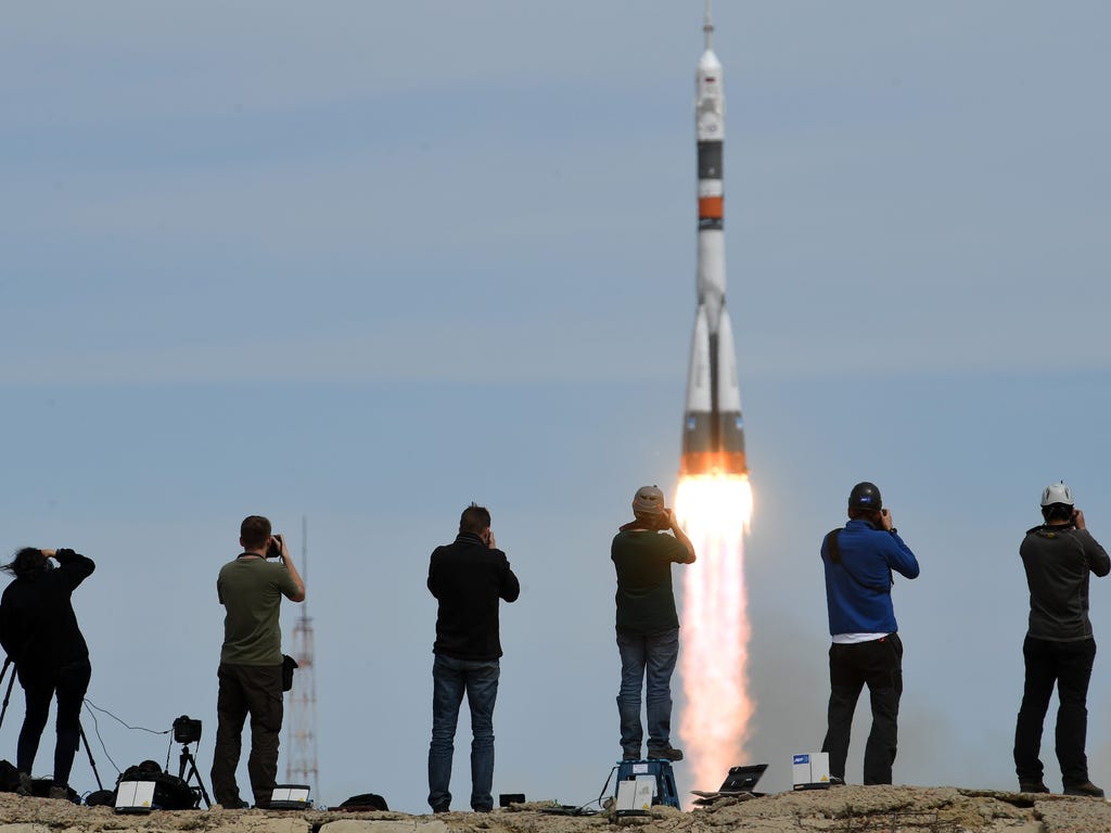 Photographers take pictures as Russia's Soyuz MS-04 spacecraft carrying Russian cosmonaut Fyodor Yurchikhin and NASA astronaut Jack David Fischer, members of the main crew of the 51\/52 expedition to the International Space Station (ISS), blasts off 