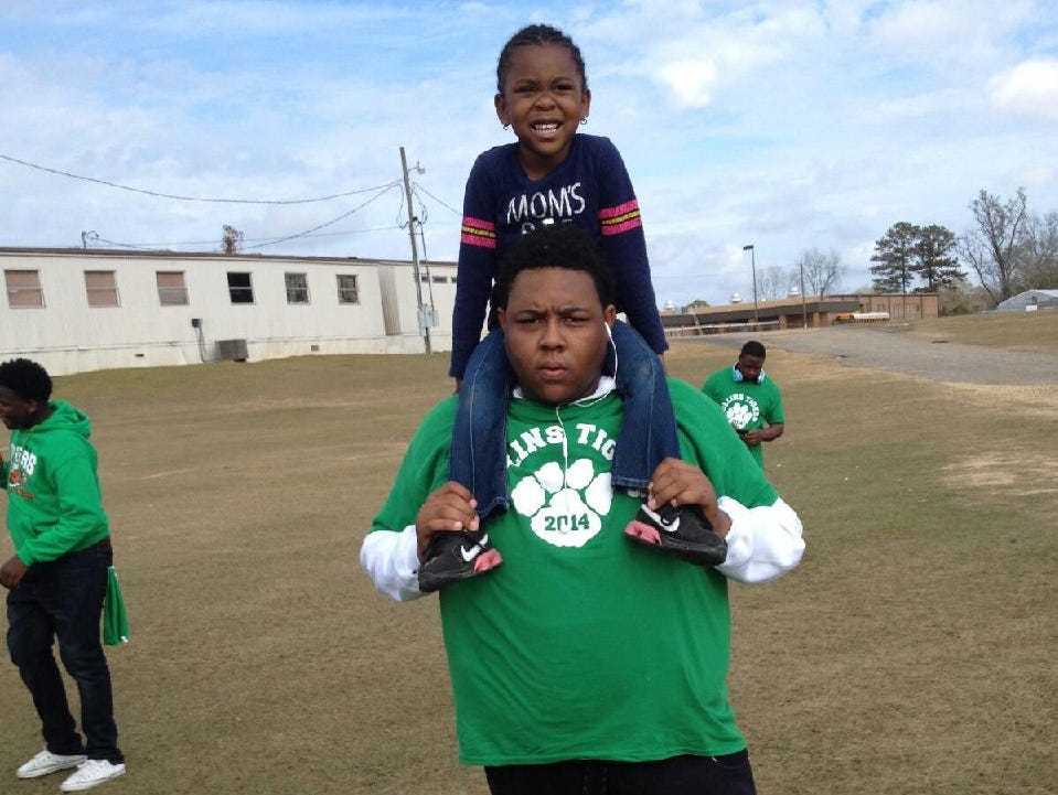 Jabarri Goudy holds his sister, Taylor, 5, on his shoulders. Goudy, 17, was killed in a shooting outside a Hattiesburg nightclub in July.