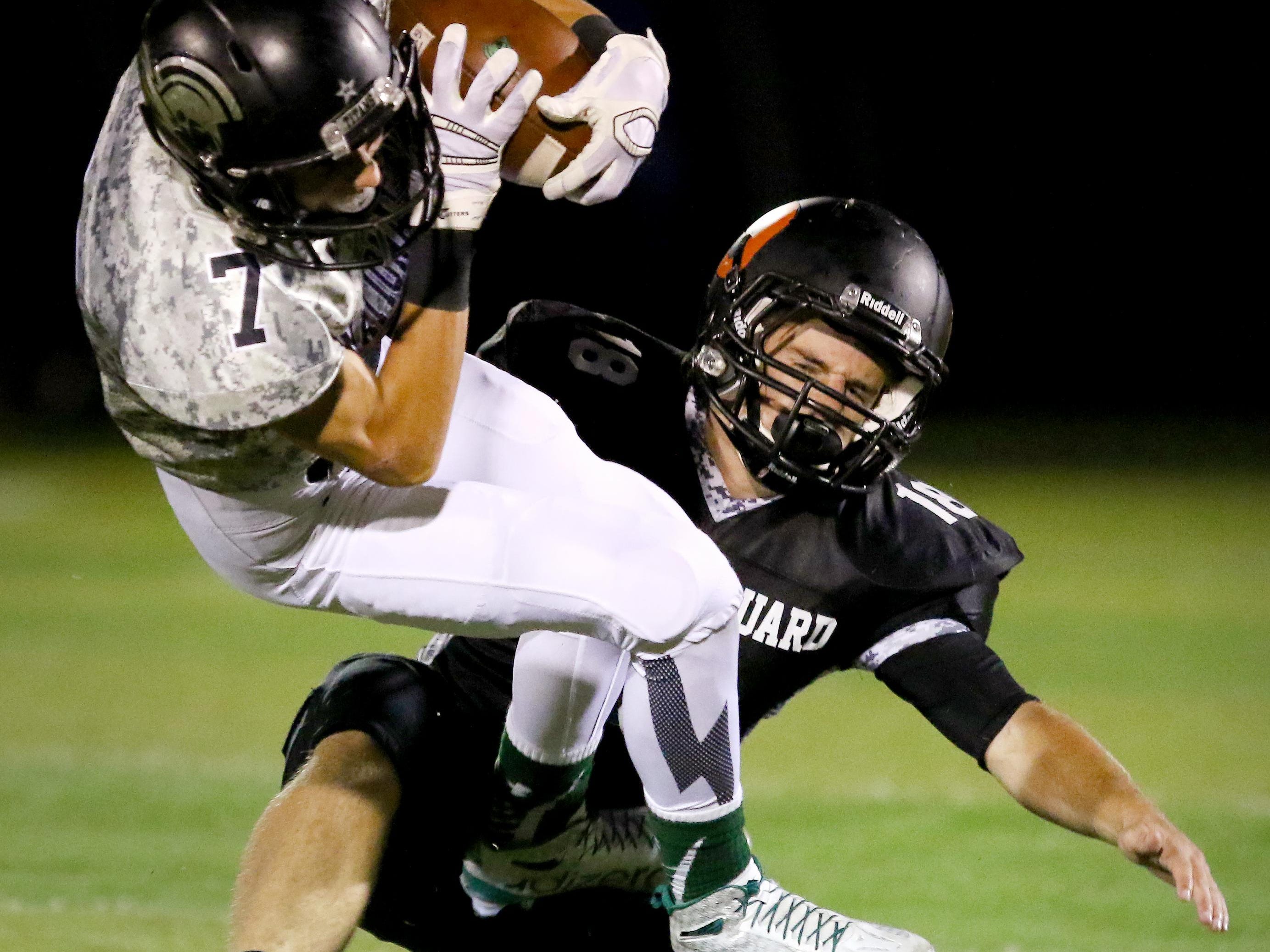 West Salem wide receiver Nate Okada is tackled by Sprague linebacker Dane McKinney during a Greater Valley Conference game, Friday, Oct. 2, 2015, in Salem, Ore.