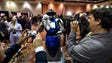 A robot draws a crowd as it roams the floor at "CES