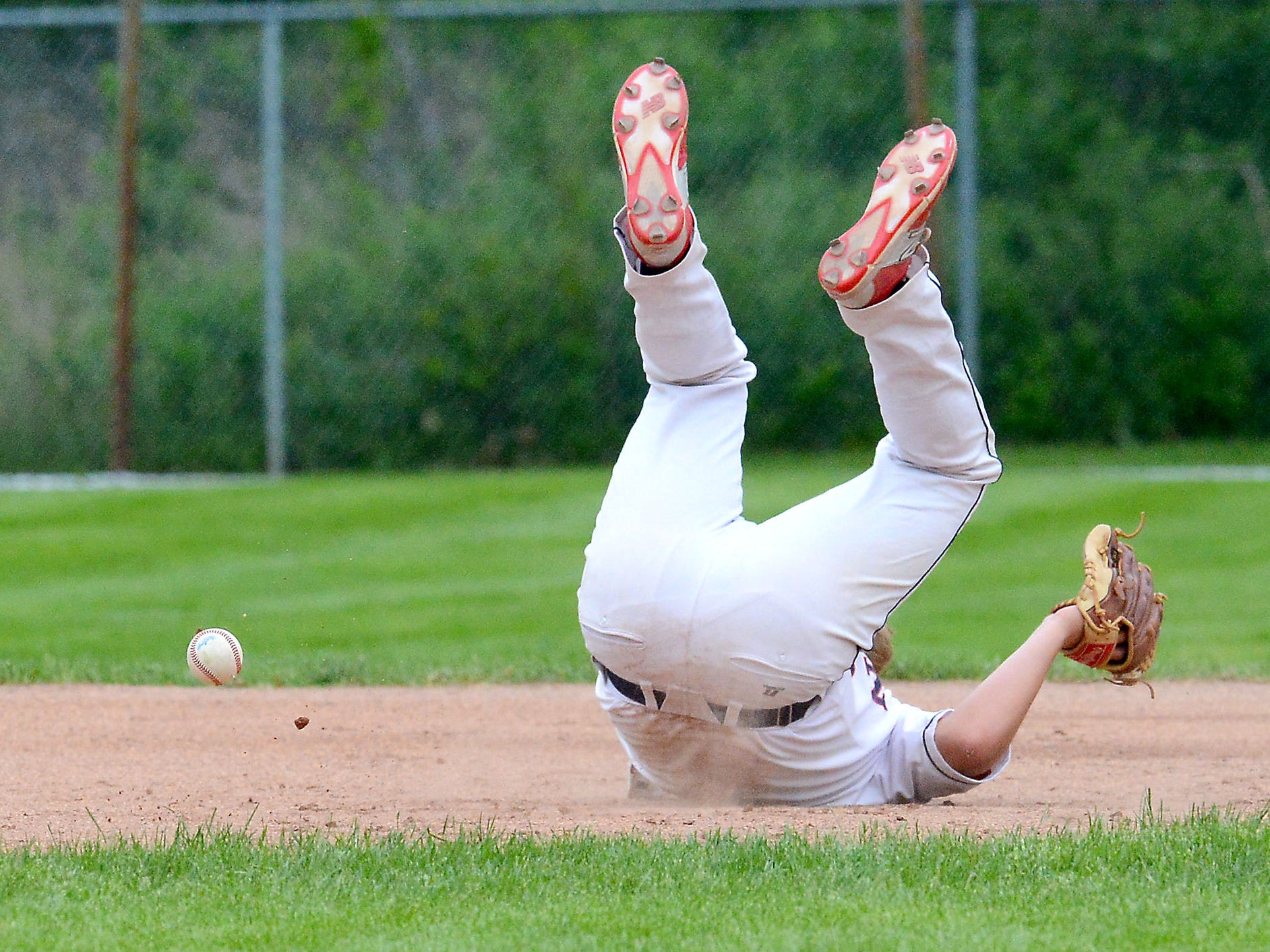 Mason third baseman Conor Whipple (9) is on the ground after being hit in the face by a ground ball Wednesday during the Bulldog's 3-2 Diamond Classic victory over Portland. Whipple would leave the game.