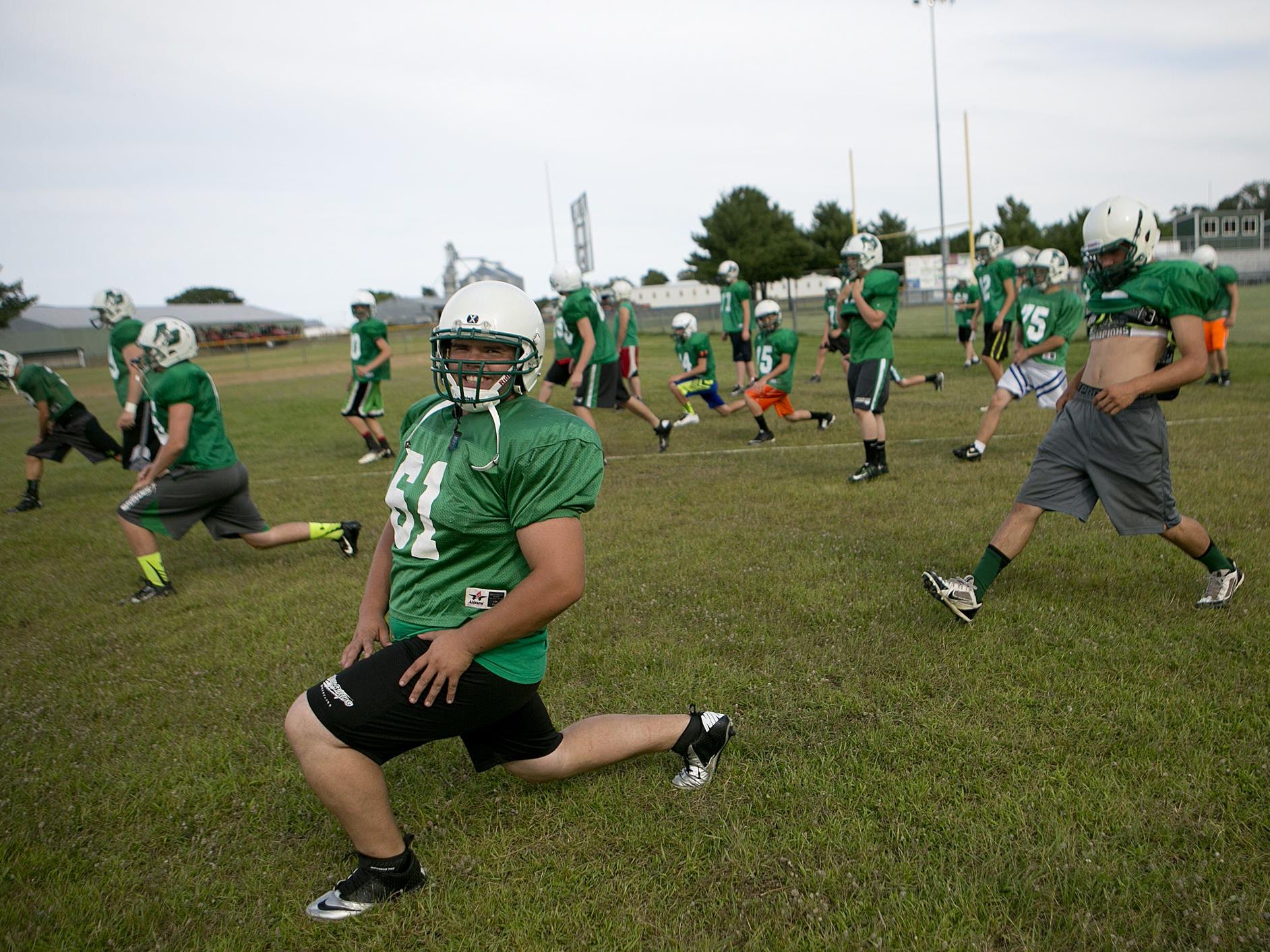 Cole Warzynski flashes a smile during warm ups Thursday at Almond-Bancroft football practice.