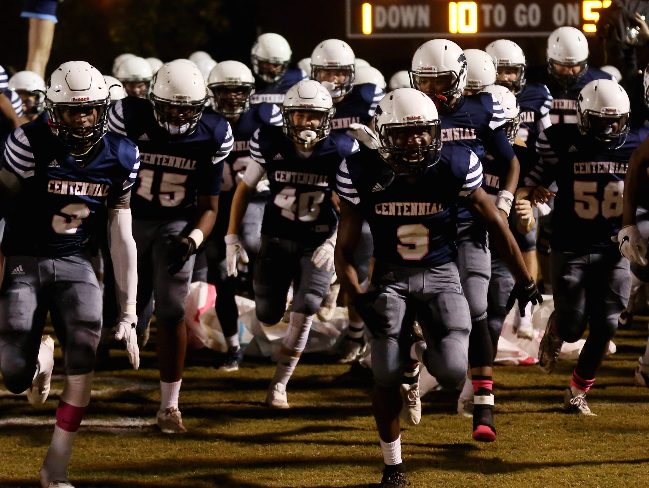 Centennial football players run onto the filed for their homegame against Brentwood Friday October 14, 2016.