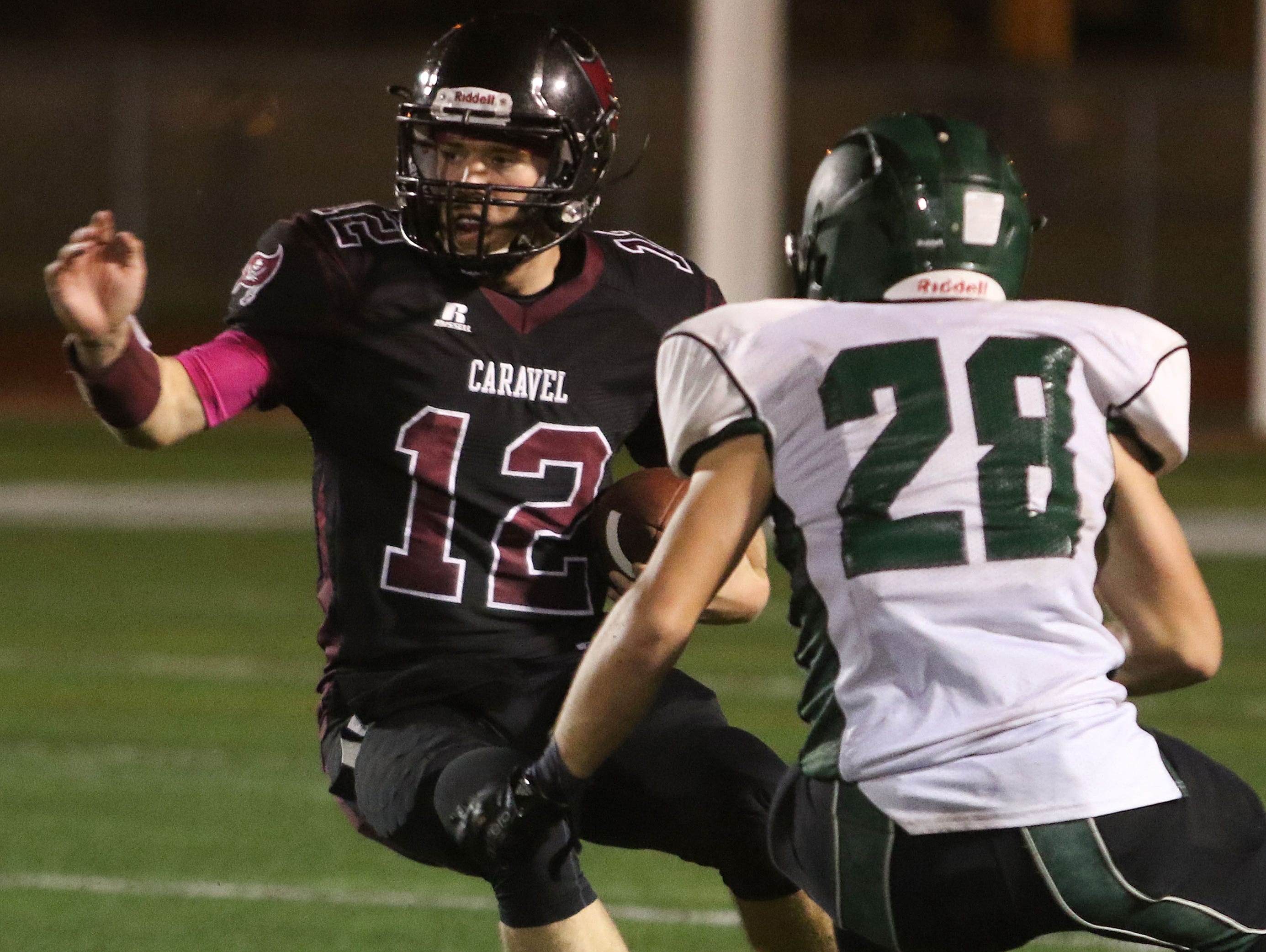 Caravel quarterback Jackson Argoe tries to cut back to avoid Archmere senior cornerback Clay Troy.