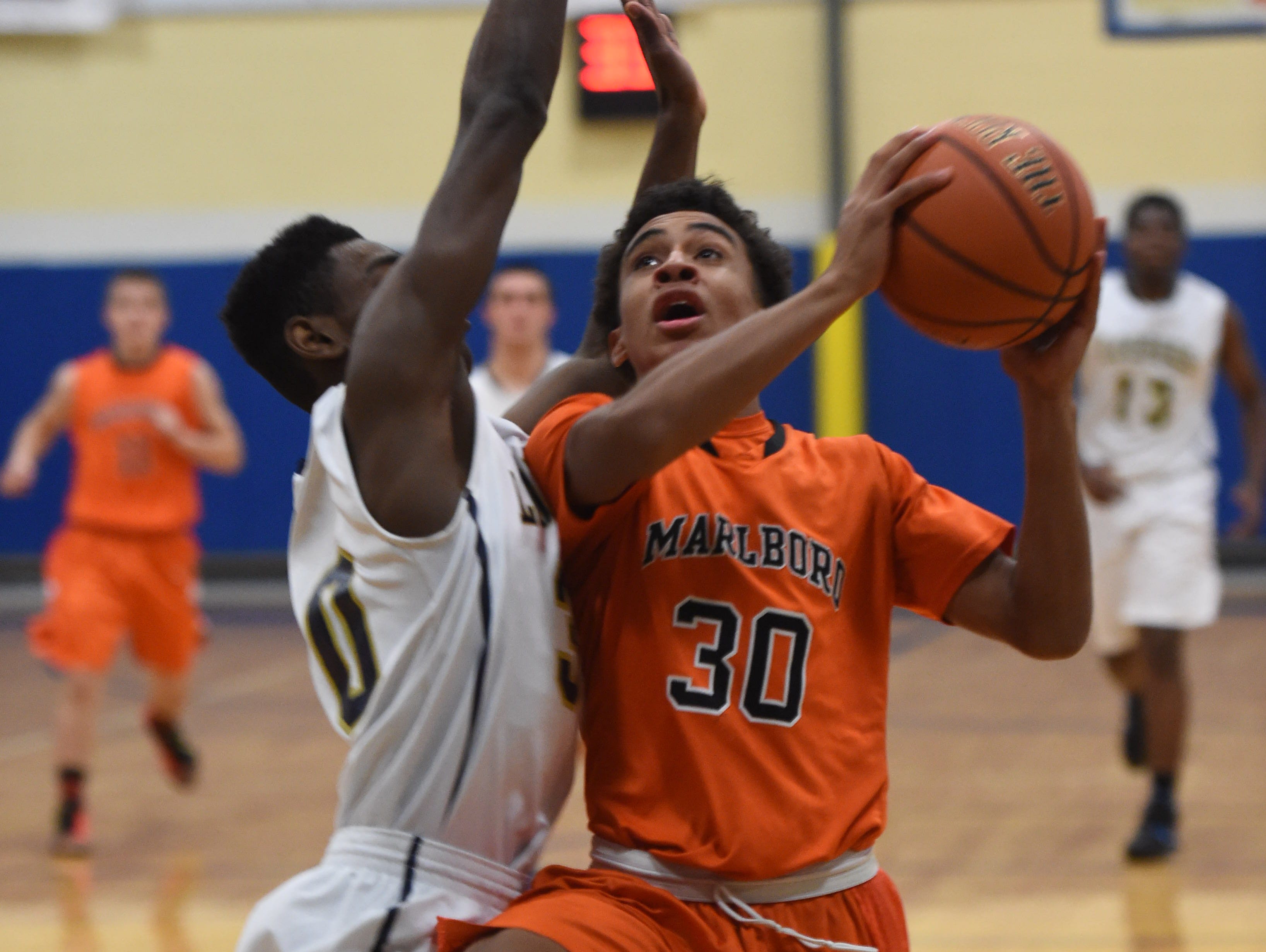 Marlboro High School's Jaiden Allen goes for a layup against Our Lady of Lourdes' Kevin Townes during the Duane Davis Memorial Holiday Tournament last December.