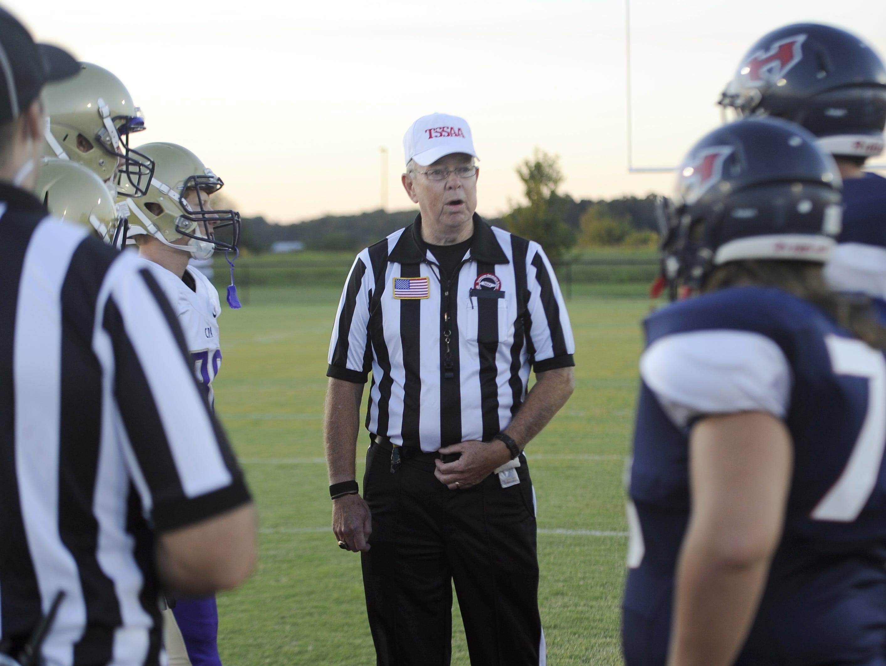 North Middle Football Officials Association referee Jody Swearingen talks with the captains prior to kickoff of last Friday's Christ Presbyterian Academy/White House Heritage game.