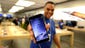 An Apple store employee shows off the new iPhone 6 on Sept. 19 at the Eaton Center in Toronto.
