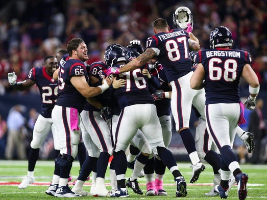 Texans players celebrate after defeating the Colts