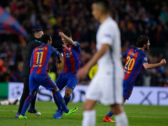 Barcelona's Neymar, Luis Suarez and Sergi Roberto celebrate with team mates at the end of the Champions League round of 16, second leg soccer match between FC Barcelona and Paris Saint Germain at the Camp Nou stadium in Barcelona, Spain, Wednesday March 8, 2017. Barcelona won the match 6-1 (6-5 on aggregate). (AP Photo/Manu Fernandez)
