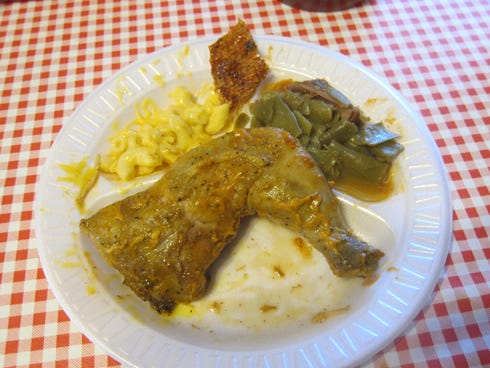 The baked chicken with the house mustard barbecue sauce, macaroni and cheese, a small piece of pork rind and string beans.