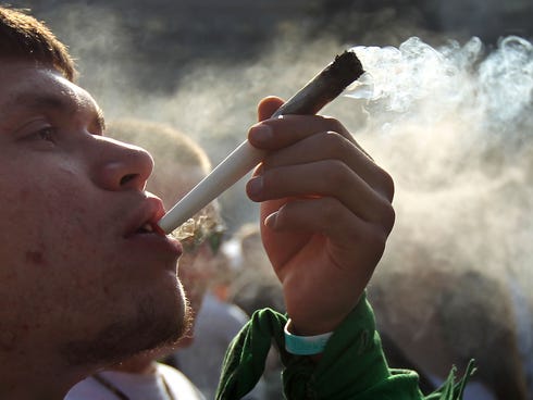A man smokes a joint at a pro-marijuana 