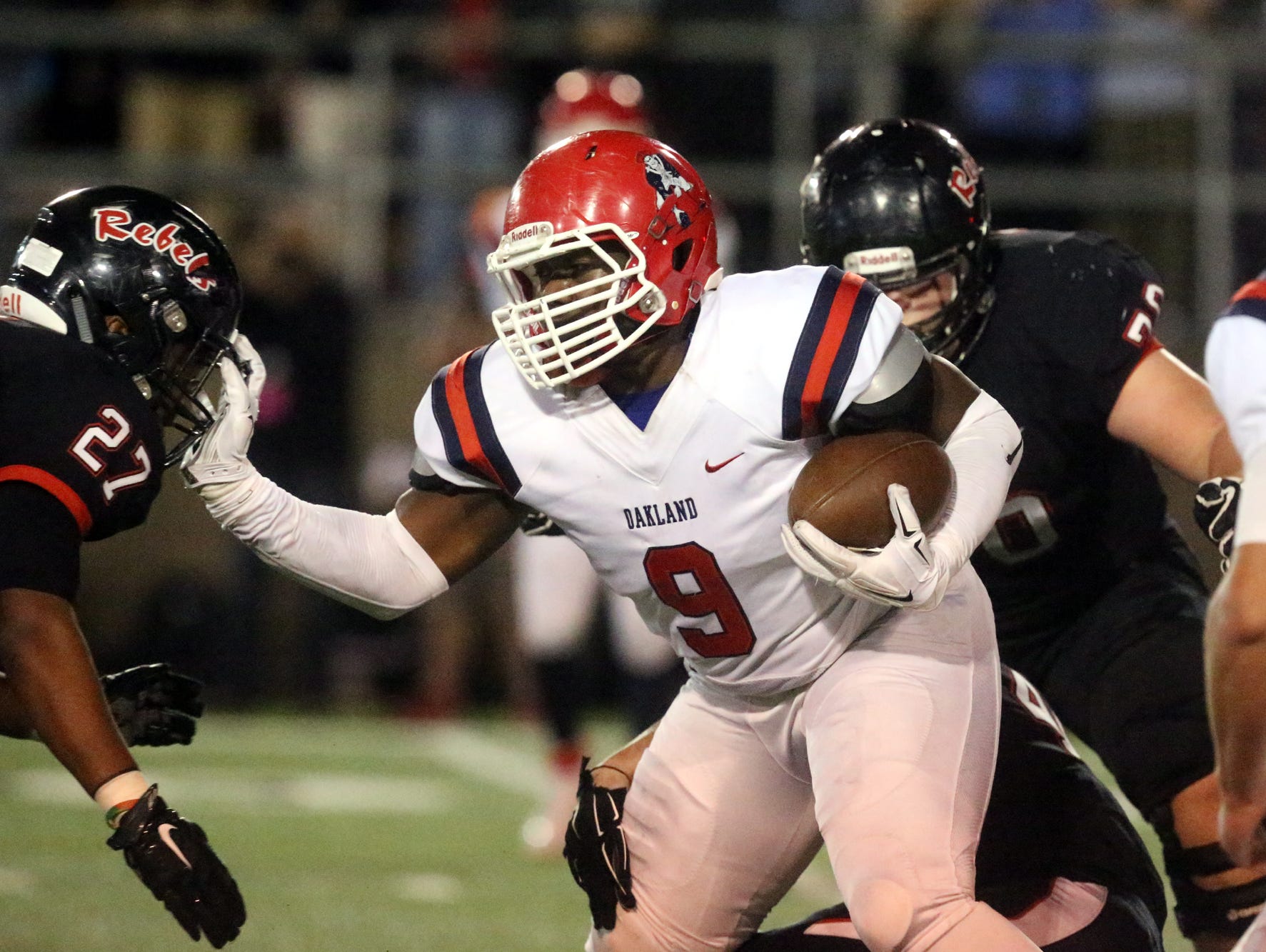 Oakland's Ty Nix (9) runs the ball as Maryville's TD Blackmon (27) moves in for the tackle Friday.