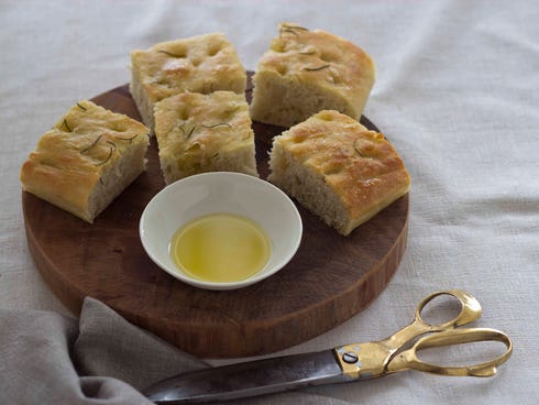 Focaccia, Italy: This thick and flat Italian bread is traditionally flavored with salt and olive oil, and topped with herbs or other ingredients such as olives or onions.
