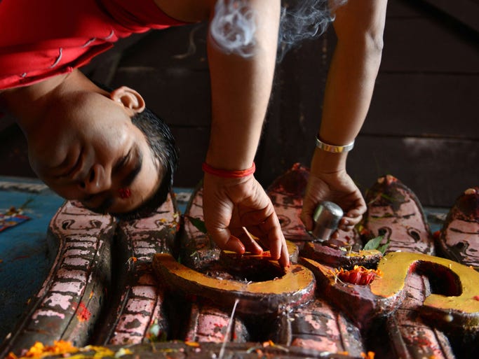 Nepalese Hindu devotees pays tribute on Aug. 1, in Kathmandu to Nag, the Hindu snake god. The Hindu festival Nag-Panchami is observed during the monsoon season with prayers and tributes to snakes.
