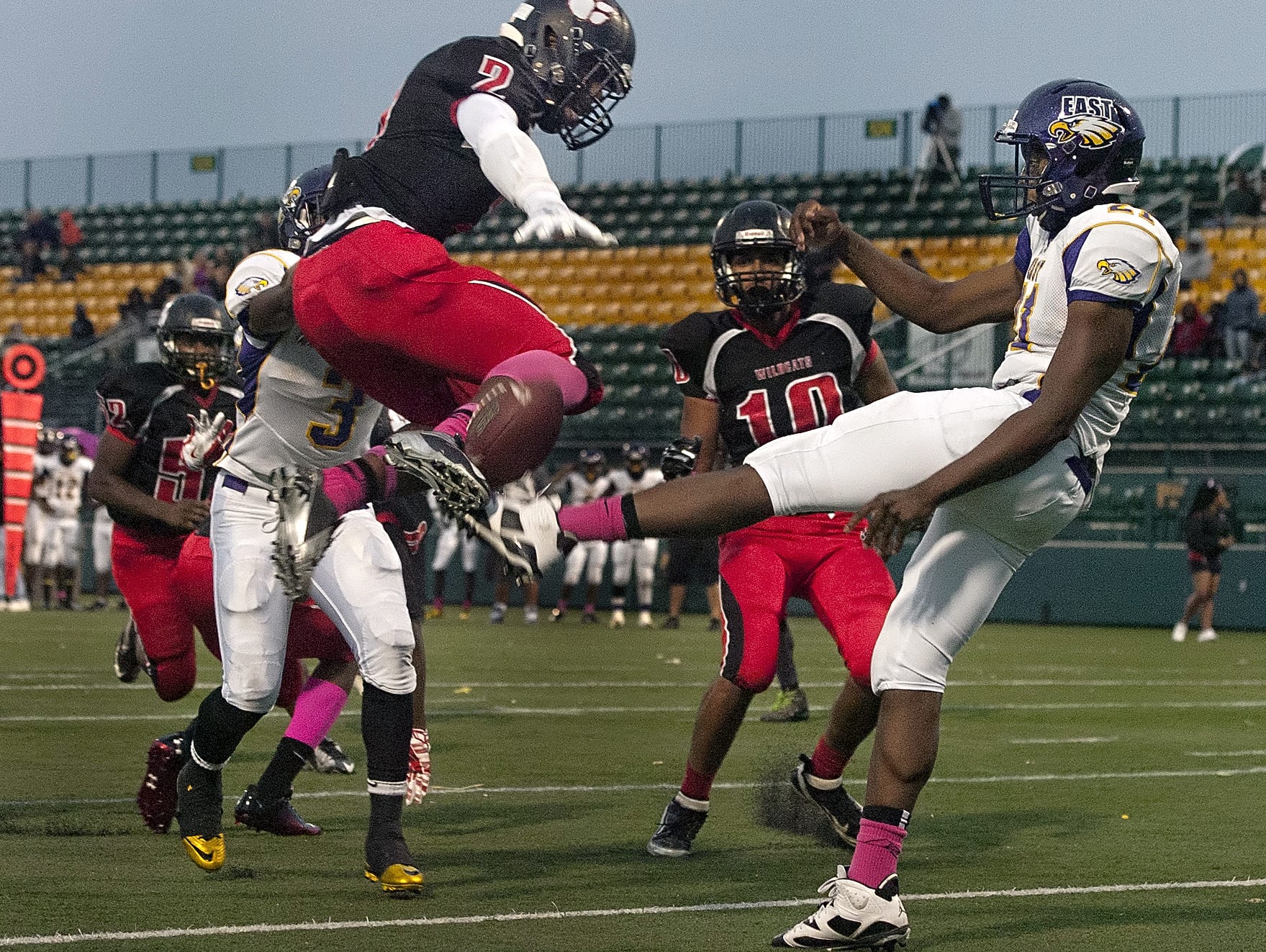 Wilson's Marvin Appleberry, left, blocks a punt by East's Davonte McClary in a RCAC regular-season game last fall at Sahlen's Stadium, which no longer will host the state football semifinals.