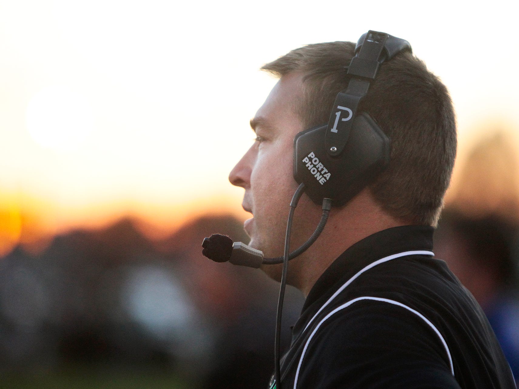 Yorktown head coach Mike Wilhelm yells to his team during their football game against New Palestine Friday, September 27, 2013, at Yorktown.